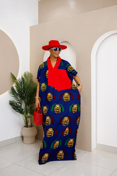 Woman in a blue Isi Agu cotton Ankara kaftan with red Aso Oke embellishment, exuding elegance.