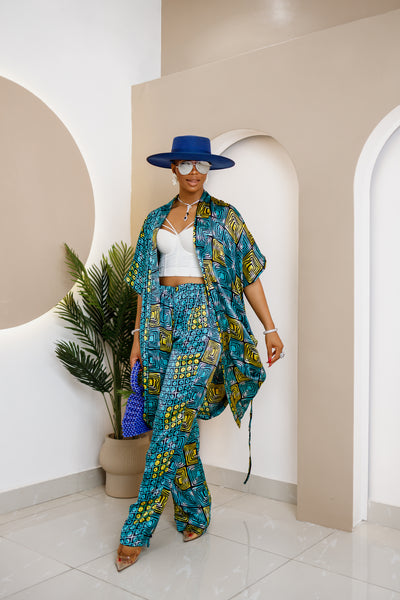 Woman wearing a vibrant blue and yellow Ankara print co-ord set with a kimono, trousers.