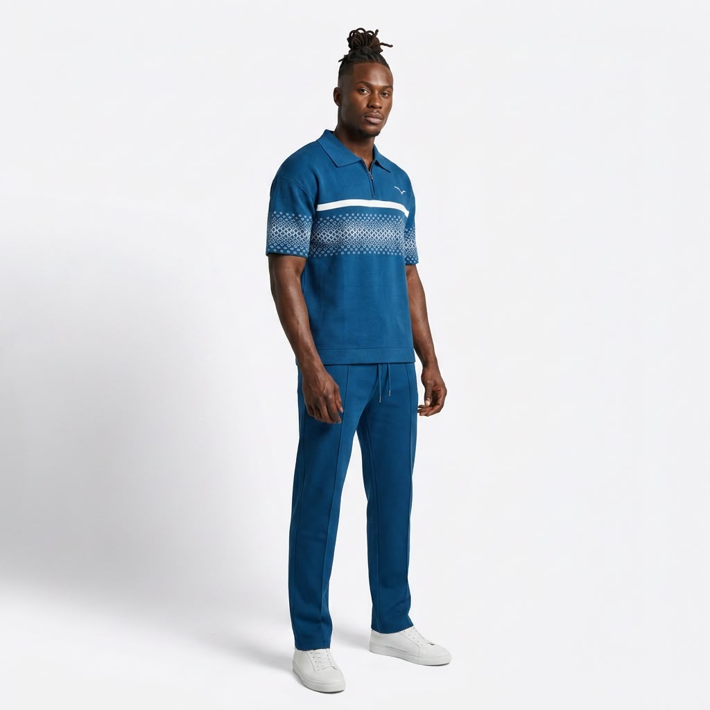 Model wearing the Anioma blue men’s athleisure set with a short-sleeve knit zip polo, geometric stripe detailing and relaxed straight-cut drawstring pants.