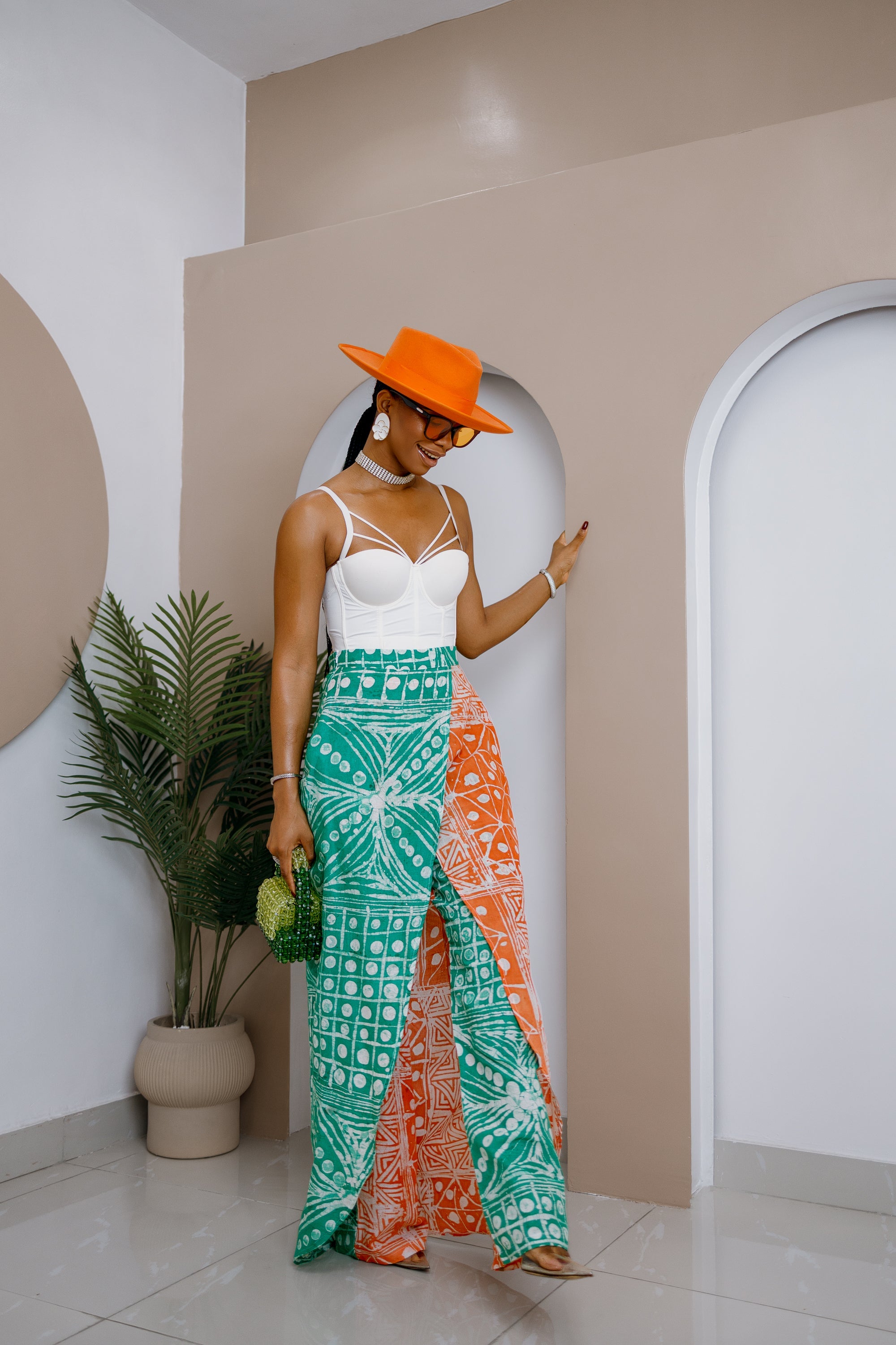 Model wearing hand-dyed Adire cotton patchwork pant skirt, African fashion, colorful cotton fabric