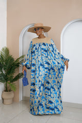 Model wearing Chikosolu floor-length silk and Aso Oke dress with yoke design, flowy sleeves, and side pockets.