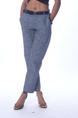 Photo of a person wearing myObioma's Azu Grey Pants, which are low-rise and straight-legged.  It includes pockets and loopholes for belts, which would add flair to the outfit. The grey and white pattern makes the pants versatile as they feel both formal and casual.