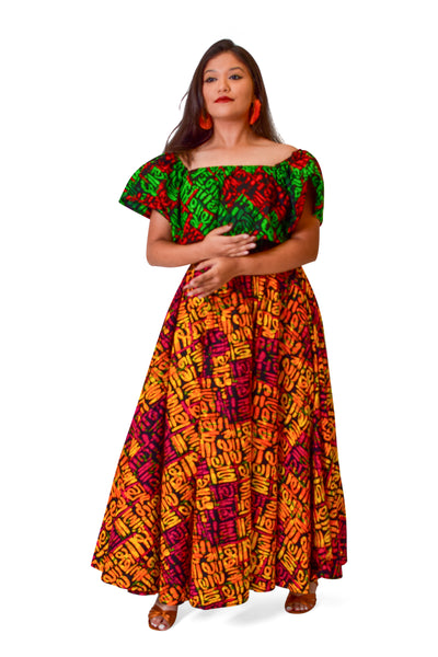 Woman wearing the Ebube Ruffle Latin One-Piece Dress, a colorful off-shoulder African Ankara maxi dress with ruffle neckline.