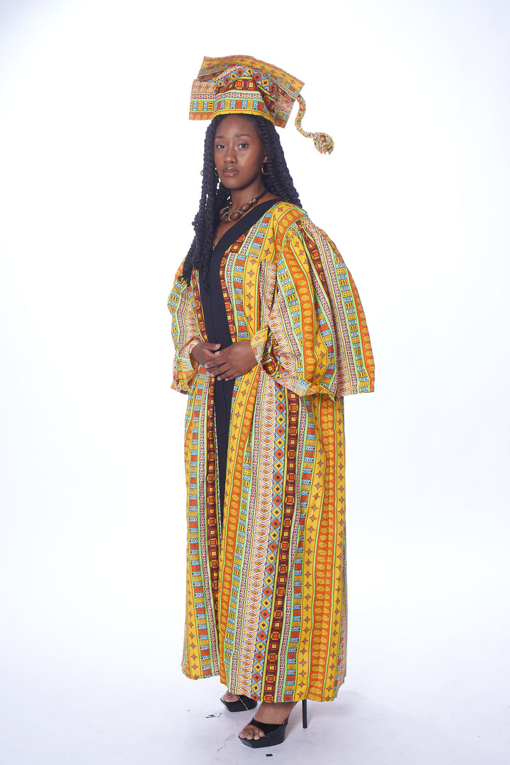 A woman wearing myObioma's Gụsịrị Graduation Outfit, which features a matching cap and gown. The celebratory cap and gown set includes a warm multicolor print with yellow, orange, and red geometric designs. 