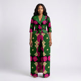 Nkowaaha tailored Ankara long jacket featuring contrast green cloverleaf lapels, three-quarter sleeves, decorative flap pockets, and a structured silhouette, handcrafted in Africa.