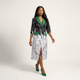Omu silk blend tailored midi dress featuring a contrasting green Aso-Oke notched lapel collar, matching waist pocket flaps, front button detailing, and elbow-length sleeves.