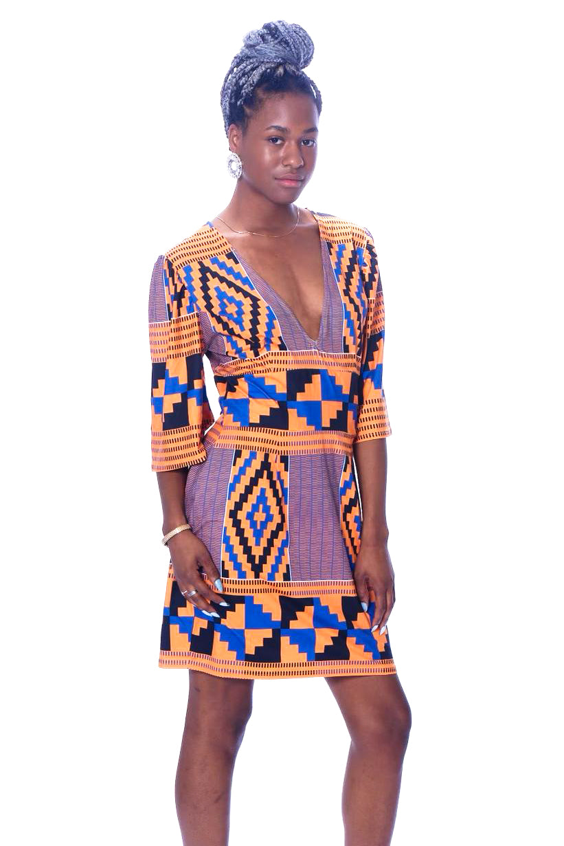 Photo of a woman wearing myObioma's Kente Short Dress, which is printed in blue and orange geometric patterns. The dress features a v-neck design and loose medium-length sleeves for a comfortable fit. It also includes a horizontal belt pattern to accentuate the waist. 
