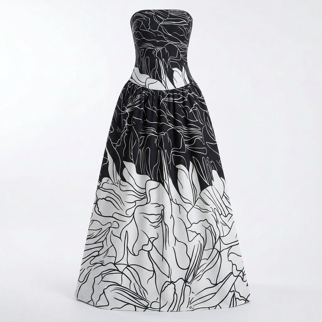 A strapless floor-length gown with a black and white floral line-art print, featuring a fitted bodice and a voluminous skirt, shown against a plain white studio background.