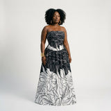 Uda silk blend strapless maxi dress featuring a fitted bodice, cinched waist, softly gathered A-line skirt, back zipper, and side pockets.
