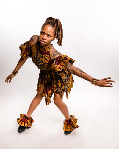 Customisable Uto Ankara dancing outfit, 4-piece set with crop top, fringed skirt, ruffled sleeves, and ankle wrap. Hand-crafted in Africa.