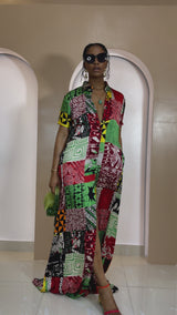 Model wearing Umuada Silk Ankara Kaftan – red, green, and yellow patchwork print maxi shirt dress with front slit.