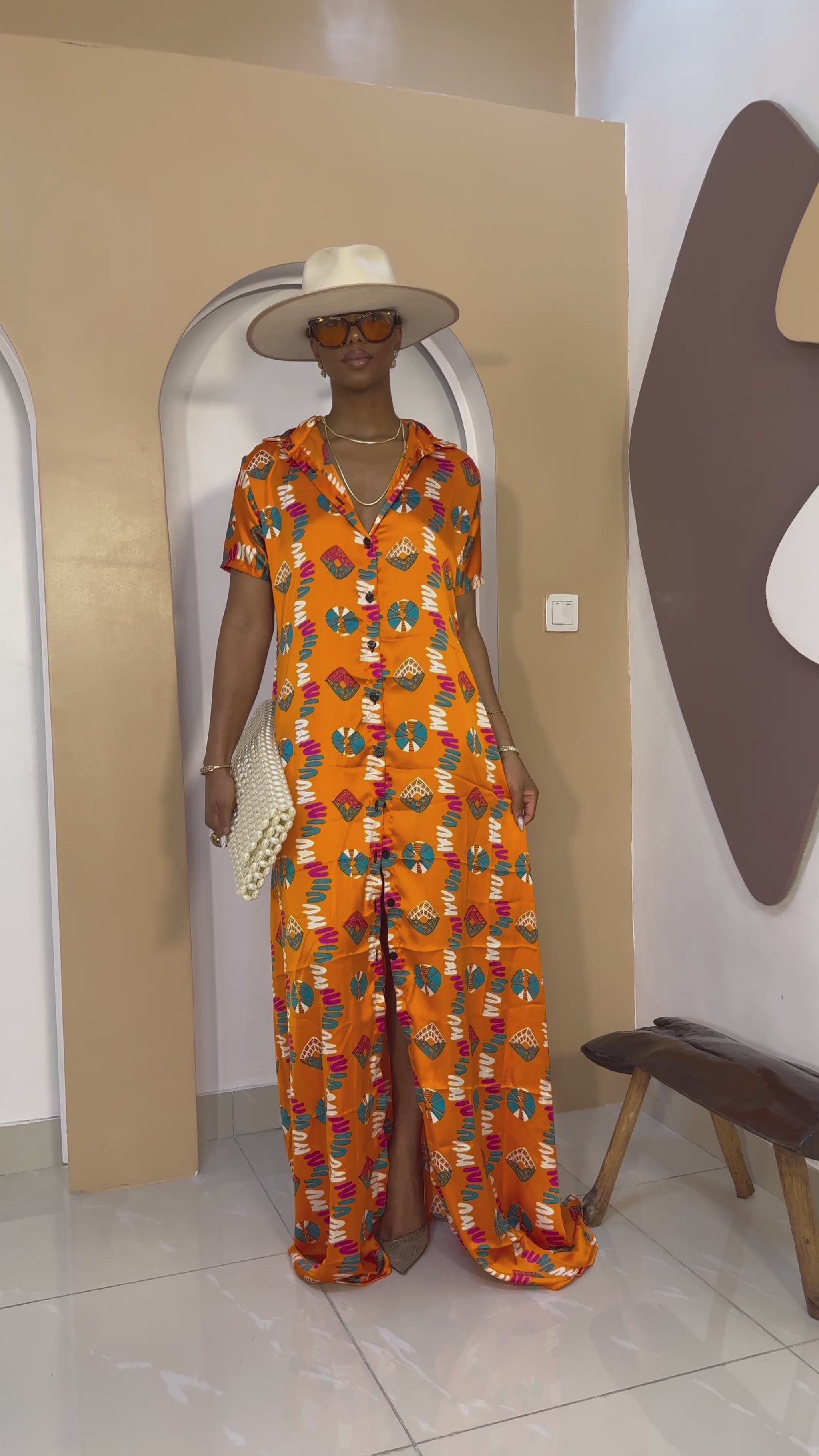 Sophisticated unlined kaftan dress made from traditional silk African Ankara fabric in vibrant multi-color patterns. Perfect for weddings, dinner parties, and formal events. Model height: 5'9".