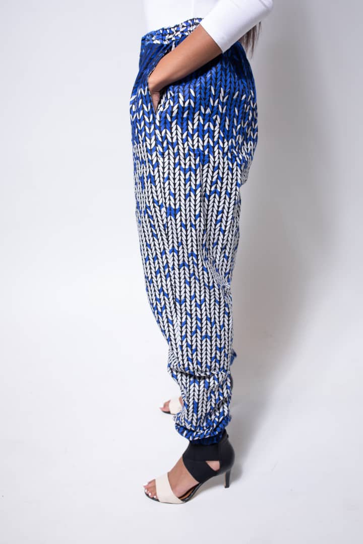 Black and white jogger pants with elastic waistband, cinched ankles, and slanted pockets.