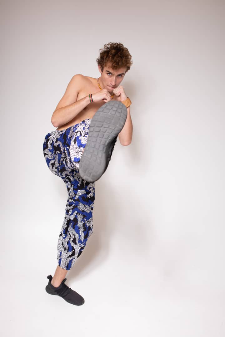 Blue, black, and white multicolored jogger pants with elastic waistband, cinched ankles, and slanted pockets.
