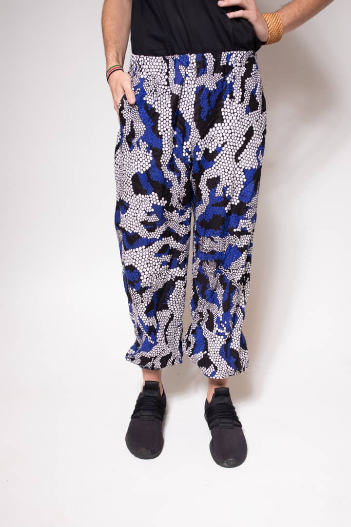 Blue, black, and white multicolored jogger pants with elastic waistband, cinched ankles, and slanted pockets.