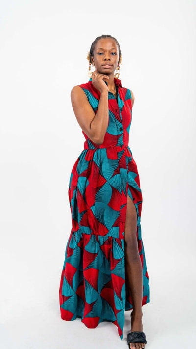 Red and blue patterned dress. Dress is sleeveless and collared, with a trumpet style silhouette and side leg slit.