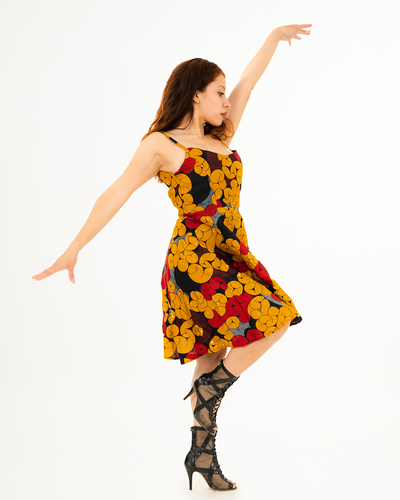 Yellow, red, and maroon patterned sun dress. This mid-length dress has spaghetti straps with a sweetheart neckline and a flowy bottom.