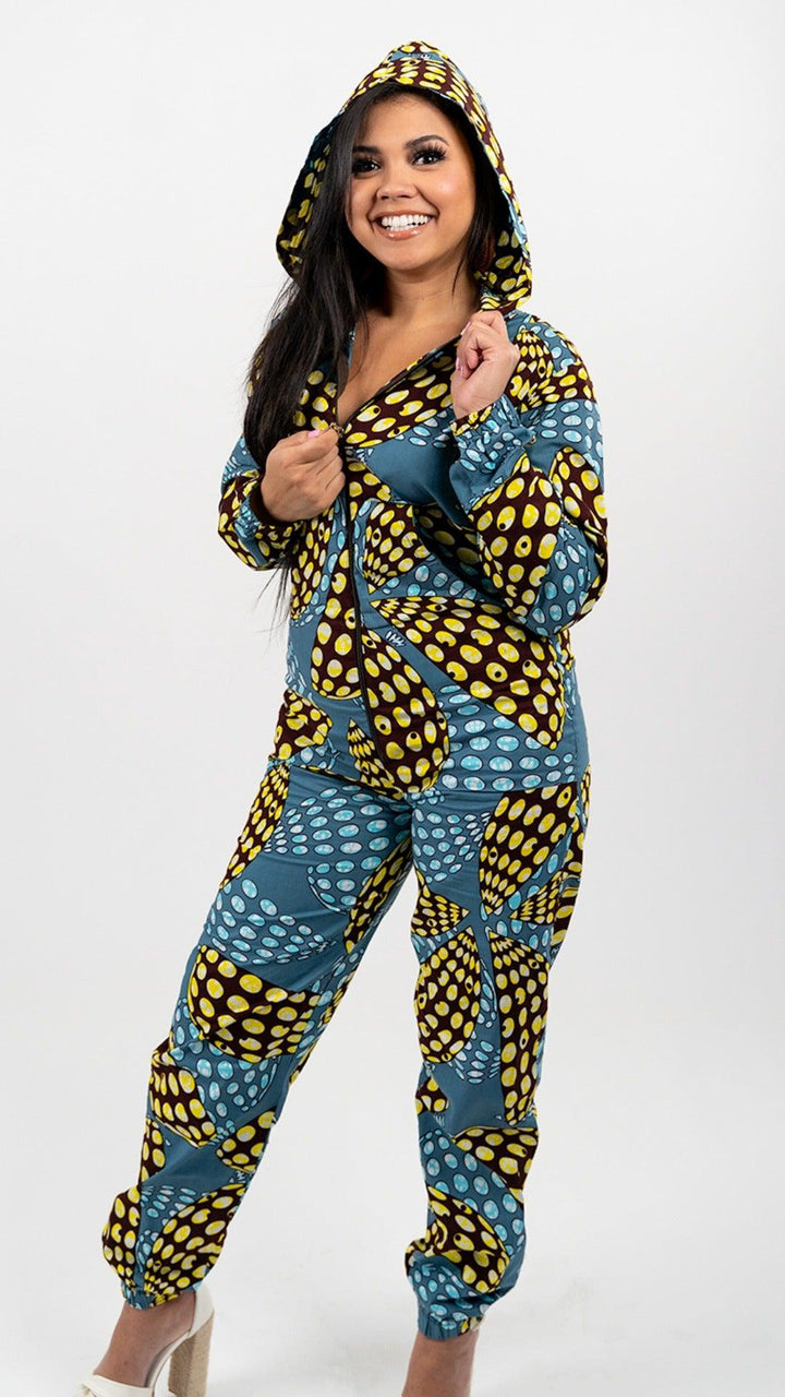 Yellow, blue, and black patterned full body onesie.  Onesie is long sleeved and hooded, with a black front zipper and elastic ankle bands.