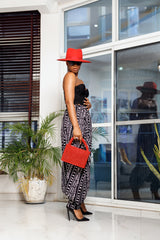 A woman posing in black and white African Print parachute pants.